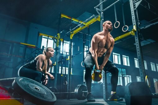 fit-young-man-lifting-barbells-working-out-in-a-gy-JUTEAYL